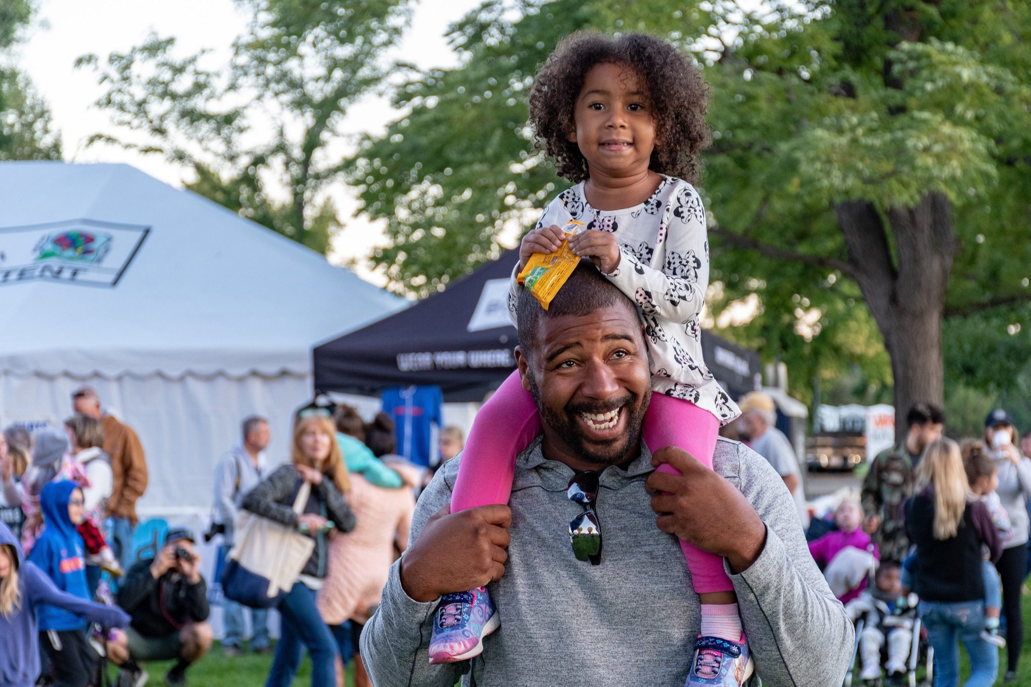 Omnicore Healthcare in Atlanta with Daughter sitting on Dads shoulders.